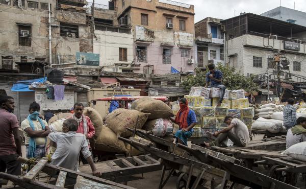 Workers and day laborers gather outside shuttered stores Monday in New Delhi. Once the world's fastest-growing major economy, India posted its steepest decline in gross domestic product in 24 years. Workers and day laborers gather outside shuttered stores Monday in New Delhi. Once the world's fastest-growing major economy, India posted its steepest decline in gross domestic product in 24 years.