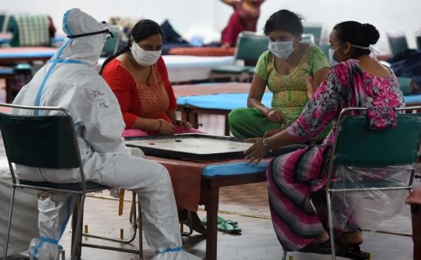 Coronavirus patients play a game of carrom inside the COVID-19 Care Centre at CWG Village Sports Complex in New Delhi on Thursday. Coronavirus patients play a game of carrom inside the COVID-19 Care Centre at CWG Village Sports Complex in New Delhi on Thursday.