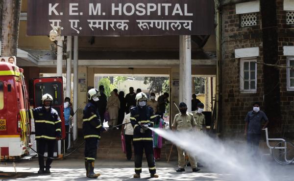Fire brigade personnel sanitize a government hospital as part of precautionary measures against the coronavirus in Mumbai, India, on Tuesday. Fire brigade personnel sanitize a government hospital as part of precautionary measures against the coronavirus in Mumbai, India, on Tuesday.