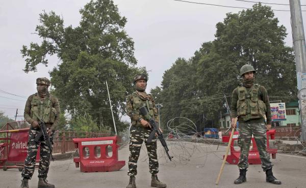 Indian paramilitary soldiers stand guard near a temporary check point on the road leading toward an Independence Day parade venue during lockdown in Srinagar, in Indian-controlled Kashmir, on Thursday. Indian Prime Minister Narendra Modi says that strippi Indian paramilitary soldiers stand guard near a temporary check point on the road leading toward an Independence Day parade venue during lockdown in Srinagar, in Indian-controlled Kashmir, on Thursday. Indian Prime Minister Narendra Modi says that strippi