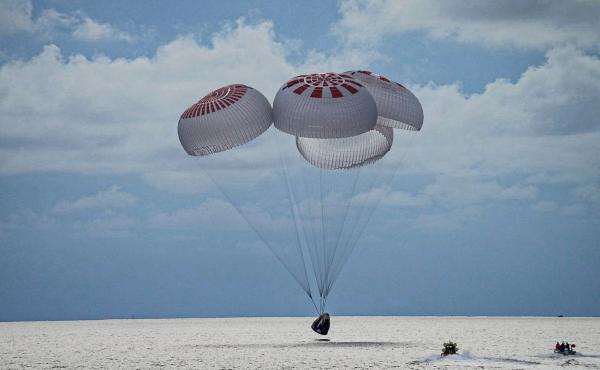 In this image provided by SpaceX, a capsule carrying the all-amateur Inspiration4 crew parachutes into the Atlantic Ocean off the Florida coast on Saturday, Sept. 18, 2021. In this image provided by SpaceX, a capsule carrying the all-amateur Inspiration4 crew parachutes into the Atlantic Ocean off the Florida coast on Saturday, Sept. 18, 2021.