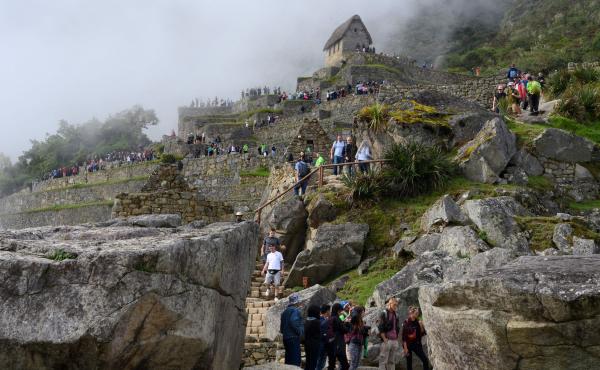 Tourists visit the Machu Picchu complex, the Inca fortress in the southeastern Andes of Peru in April. The government hopes a new airport will attract more tourists to the ancient site. That draws opposition from conservationists. Tourists visit the Machu Picchu complex, the Inca fortress in the southeastern Andes of Peru in April. The government hopes a new airport will attract more tourists to the ancient site. That draws opposition from conservationists.