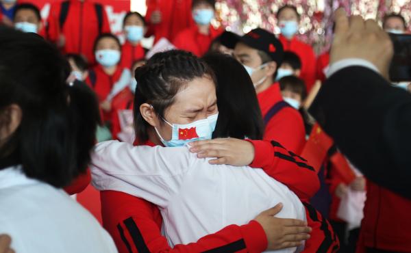 Health workers from Tongji Hospital in Wuhan, China, share an emotional embrace with their peers from a hospital in Jilin province at the Tianhe Airport. Colleagues who worked on the front lines together bid farewell as Wuhan lifted its coronavirus lockdo Health workers from Tongji Hospital in Wuhan, China, share an emotional embrace with their peers from a hospital in Jilin province at the Tianhe Airport. Colleagues who worked on the front lines together bid farewell as Wuhan lifted its coronavirus lockdo