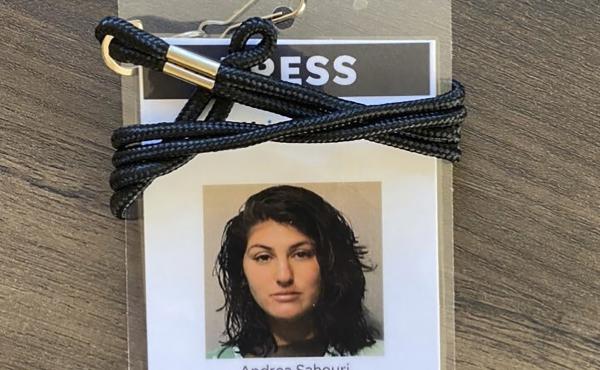 A press badge for Des Moines Register reporter Andrea Sahouri features the jail booking photo from her May 31 arrest while covering a Black Lives Matter protest. A press badge for Des Moines Register reporter Andrea Sahouri features the jail booking photo from her May 31 arrest while covering a Black Lives Matter protest.