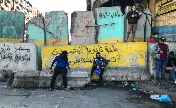 Protesters near Baghdad's Tahrir Square. The concrete barriers have been erected by security forces who are trying to prevent demonstrations from moving closer to Baghdad's fortified Green Zone. Protesters near Baghdad's Tahrir Square. The concrete barriers have been erected by security forces who are trying to prevent demonstrations from moving closer to Baghdad's fortified Green Zone.