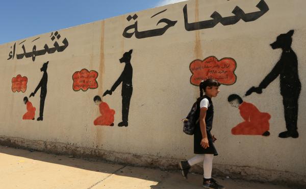 In Mosul, reminders of the Islamic State's brutal rule include a school wall covered with drawings showing how militants executed their prisoners. The U.N. says the area around the city holds mass graves where thousands of people were buried. In Mosul, reminders of the Islamic State's brutal rule include a school wall covered with drawings showing how militants executed their prisoners. The U.N. says the area around the city holds mass graves where thousands of people were buried.