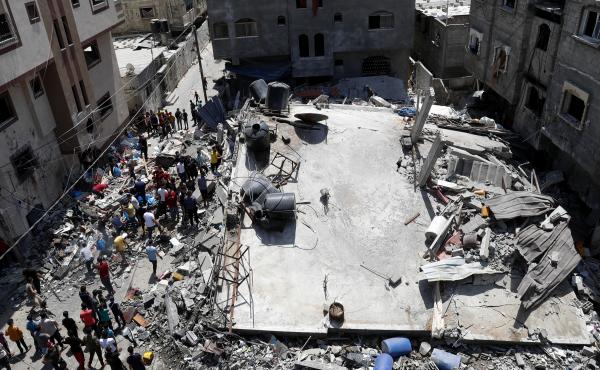 People gather near the rubble of a residential building hit by Israeli airstrikes Thursday in Beit Lahiya, Gaza Strip. People gather near the rubble of a residential building hit by Israeli airstrikes Thursday in Beit Lahiya, Gaza Strip.
