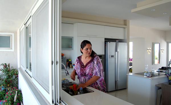 Adi Asulin stands in the kitchen of her family's remodeled apartment north of Tel Aviv. She saved thousands of dollars by flying to China to buy furnishings and flooring directly from manufacturers. Adi Asulin stands in the kitchen of her family's remodeled apartment north of Tel Aviv. She saved thousands of dollars by flying to China to buy furnishings and flooring directly from manufacturers.