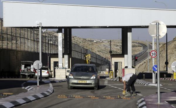 A checkpoint is seen on a West Bank highway near Jerusalem which critics have branded an "apartheid highway." The highway features a large concrete wall segregating Israeli and Palestinian traffic. A checkpoint is seen on a West Bank highway near Jerusalem which critics have branded an "apartheid highway." The highway features a large concrete wall segregating Israeli and Palestinian traffic.
