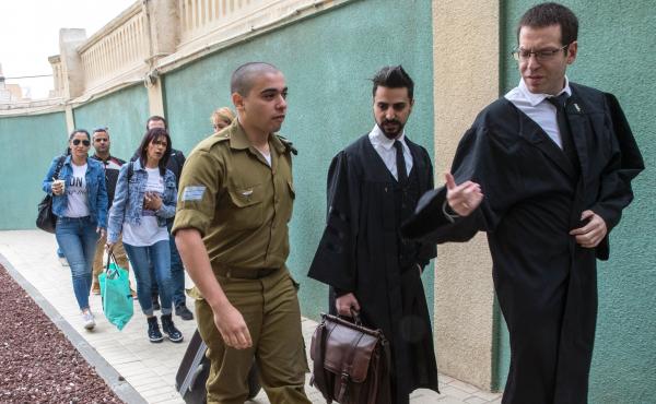 Israeli soldier Elor Azaria, who was caught on video shooting a wounded Palestinian assailant in the head as he lay on the ground, speaks with his lawyers upon his arrival for a hearing at a military appeals court in Tel Aviv on Nov. 23, 2016. Azaria has Israeli soldier Elor Azaria, who was caught on video shooting a wounded Palestinian assailant in the head as he lay on the ground, speaks with his lawyers upon his arrival for a hearing at a military appeals court in Tel Aviv on Nov. 23, 2016. Azaria has