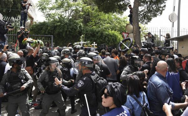 Israeli police in riot gear confront mourners and the journalists on Friday covering the transfer from the hospital of slain Al Jazeera veteran journalist Shireen Abu Akleh to her final resting place in east Jerusalem. Abu Akleh, a Palestinian-American re Israeli police in riot gear confront mourners and the journalists on Friday covering the transfer from the hospital of slain Al Jazeera veteran journalist Shireen Abu Akleh to her final resting place in east Jerusalem. Abu Akleh, a Palestinian-American re