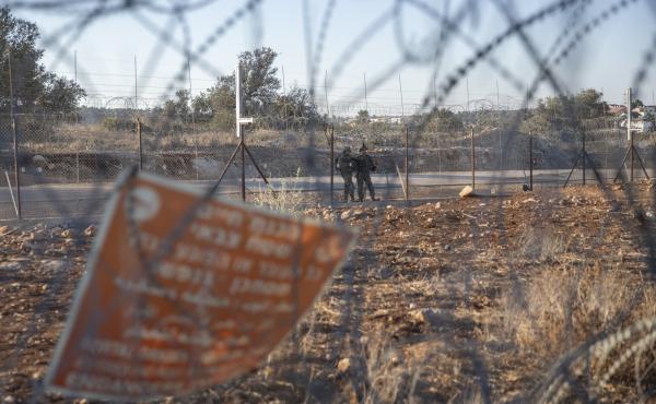 Israeli army soldiers guard a section of Israel's separation barrier last year in the West Bank village of Nilin, west of Ramallah. Two Palestinian men were critically injured by Israeli forces in the occupied West Bank on Monday, the Palestinian Health M Israeli army soldiers guard a section of Israel's separation barrier last year in the West Bank village of Nilin, west of Ramallah. Two Palestinian men were critically injured by Israeli forces in the occupied West Bank on Monday, the Palestinian Health M