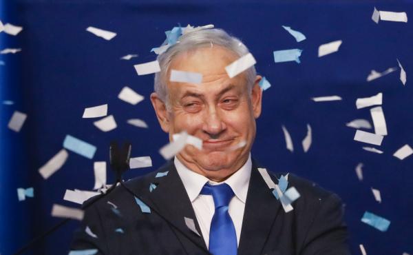 Israeli Prime Minister Benjamin Netanyahu smiles after first exit poll results for the Israeli elections at his party's headquarters in Tel Aviv, Israel, on Monday. Israeli Prime Minister Benjamin Netanyahu smiles after first exit poll results for the Israeli elections at his party's headquarters in Tel Aviv, Israel, on Monday.