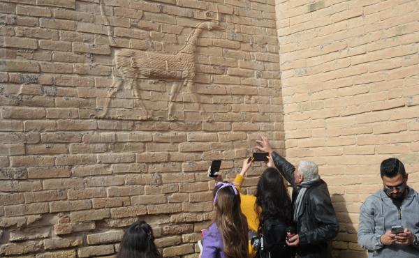 Visitors with the Bil Weekend tourism company take photographs inside the ruins of the ancient city of Babylon, in the area around the Ishtar gate. The animal on the walls ins a dragon-like creature associated with the Babylonian god Marduk. Visitors with the Bil Weekend tourism company take photographs inside the ruins of the ancient city of Babylon, in the area around the Ishtar gate. The animal on the walls ins a dragon-like creature associated with the Babylonian god Marduk.