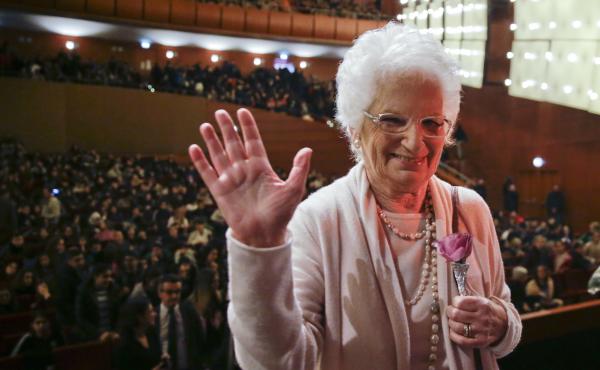 Liliana Segre waves at the end of a meeting with students in Milan, Italy, in 2018. For decades, Segre, 89, was reluctant to discuss her time in the Auschwitz concentration camp. But in the 1990s, she began speaking to schoolchildren throughout Italy abou Liliana Segre waves at the end of a meeting with students in Milan, Italy, in 2018. For decades, Segre, 89, was reluctant to discuss her time in the Auschwitz concentration camp. But in the 1990s, she began speaking to schoolchildren throughout Italy abou