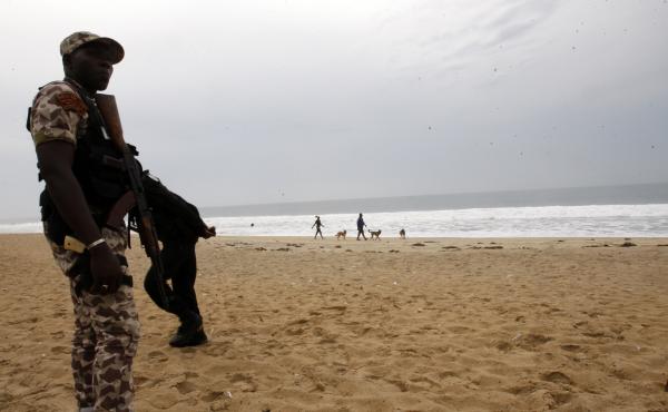 An Ivorian soldier stands guard on March 18, 2016 at the site of a jihadist shooting rampage at the beach resort of Grand Bassam. An Ivorian soldier stands guard on March 18, 2016 at the site of a jihadist shooting rampage at the beach resort of Grand Bassam.