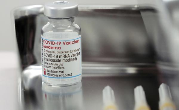 This June 14, 2021, file photo shows a Moderna COVID-19 vaccine vial that is being administered for flight attendants of Japan Airlines at Haneda Airport in Tokyo. This June 14, 2021, file photo shows a Moderna COVID-19 vaccine vial that is being administered for flight attendants of Japan Airlines at Haneda Airport in Tokyo.
