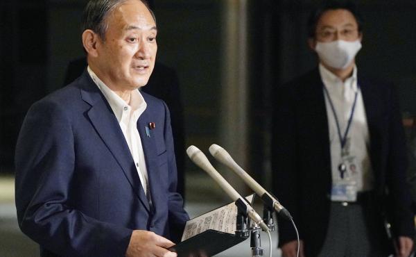 Japanese Prime Minister Yoshihide Suga speaks to reporters about lifting of a state of emergency at his official residence in Tokyo Monday, Sept. 27. Suga announced Tuesday a lifting of the ongoing coronavirus state of emergency and less-stringent measure Japanese Prime Minister Yoshihide Suga speaks to reporters about lifting of a state of emergency at his official residence in Tokyo Monday, Sept. 27. Suga announced Tuesday a lifting of the ongoing coronavirus state of emergency and less-stringent measure