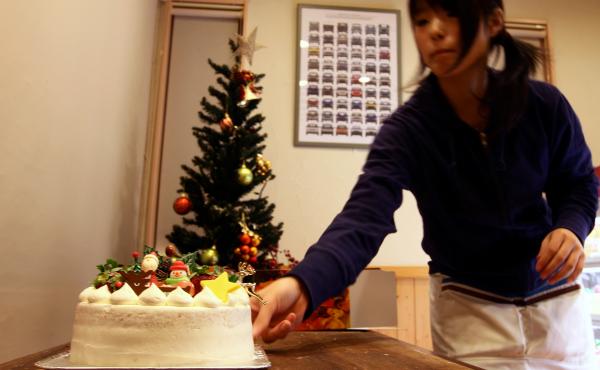 A woman prepares a Japanese Christmas cake at the Patisserie Akira Cake shop on Dec. 23, 2011. The sponge cake is drenched in symbolic meaning. A woman prepares a Japanese Christmas cake at the Patisserie Akira Cake shop on Dec. 23, 2011. The sponge cake is drenched in symbolic meaning.