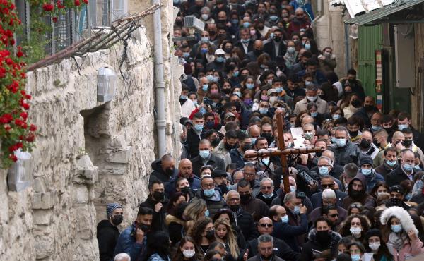 Christian worshippers carry a wooden cross on Friday along the path where tradition says Jesus took his final steps before his crucifixion in Jerusalem's Old City. Christian worshippers carry a wooden cross on Friday along the path where tradition says Jesus took his final steps before his crucifixion in Jerusalem's Old City.