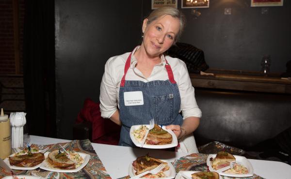 Chef Heidi Rae Weinstein holds a Reuben sandwich, complete with Swiss cheese — definitely a kosher no-no — at Trefa Banquet 2.0, an event held in San Francisco to commemorate a scandalous meal held in 1883 by newly ordained rabbis of the Jewish reform Chef Heidi Rae Weinstein holds a Reuben sandwich, complete with Swiss cheese — definitely a kosher no-no — at Trefa Banquet 2.0, an event held in San Francisco to commemorate a scandalous meal held in 1883 by newly ordained rabbis of the Jewish reform