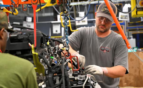 Workers assemble engines along the line at a General Motors plant in Spring Hill, Tenn. A nationwide strike by the United Automobile Workers at GM plants didn't hurt U.S. job growth in October. Workers assemble engines along the line at a General Motors plant in Spring Hill, Tenn. A nationwide strike by the United Automobile Workers at GM plants didn't hurt U.S. job growth in October.