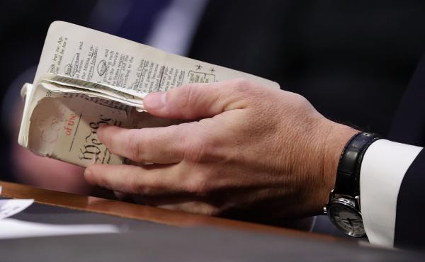 Supreme Court nominee Judge Brett Kavanaugh thumbs through a well-worn, pocket-sized copy of the U.S. Constitution as he testifies before the Senate Judiciary Committee on the second day of his confirmation hearings Wednesday. Supreme Court nominee Judge Brett Kavanaugh thumbs through a well-worn, pocket-sized copy of the U.S. Constitution as he testifies before the Senate Judiciary Committee on the second day of his confirmation hearings Wednesday.
