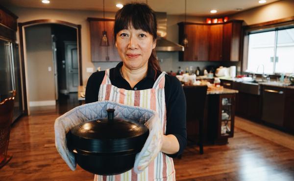 The author's mother, Jenna Cho, holding a pot of samgyetang in her home in Mercer Island, Wash. The author's mother, Jenna Cho, holding a pot of samgyetang in her home in Mercer Island, Wash.