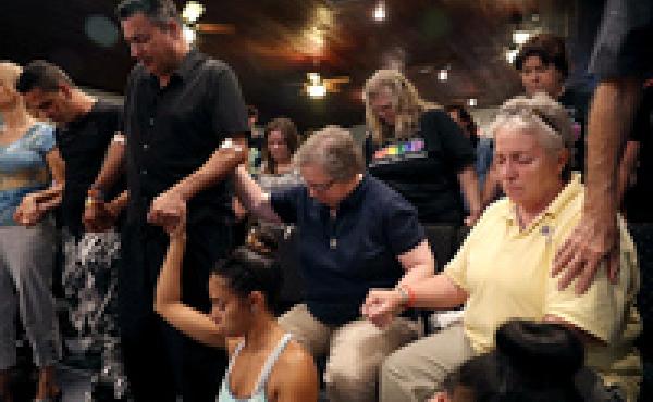 Orlando (who did not want to provide his last name; second from left), who was injured in the mass shooting at the Pulse Nightclub, attends a memorial service at the Joy MCC Church in Orlando, Fla. Orlando (who did not want to provide his last name; second from left), who was injured in the mass shooting at the Pulse Nightclub, attends a memorial service at the Joy MCC Church in Orlando, Fla.