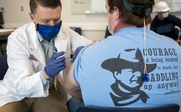 A pharmacist administers a dose of a COVID-19 vaccine to a worker at a processing plant in Arkansas City, Kan., on March 5. Researchers are concerned that vaccination rates in some rural communities may not keep up with urban rates. A pharmacist administers a dose of a COVID-19 vaccine to a worker at a processing plant in Arkansas City, Kan., on March 5. Researchers are concerned that vaccination rates in some rural communities may not keep up with urban rates.