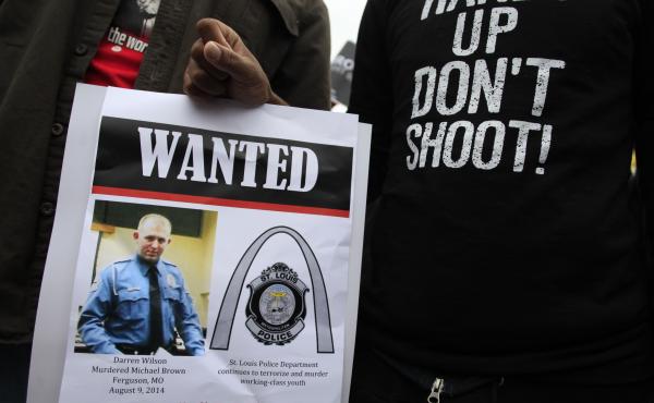 Demonstrators hold a sign in St. Louis, Mo., following the 2014 shooting death of 18-year-old Michael Brown. Demonstrators hold a sign in St. Louis, Mo., following the 2014 shooting death of 18-year-old Michael Brown.