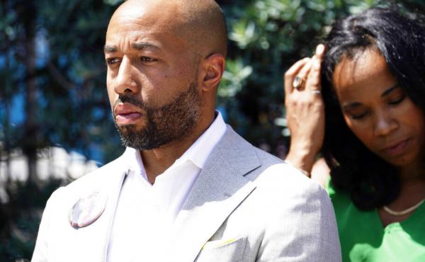 Charles Johnson wears a button with a picture of his wife, Kira, during a press conference announcing a lawsuit outside Cedars-Sinai Medical Center, Wednesday in Los Angeles. Kira Johnson died at the hospital in 2016 from complications after giving birth Charles Johnson wears a button with a picture of his wife, Kira, during a press conference announcing a lawsuit outside Cedars-Sinai Medical Center, Wednesday in Los Angeles. Kira Johnson died at the hospital in 2016 from complications after giving birth
