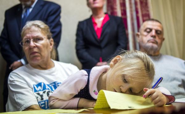 Flint, Mich., resident Jacqueline Pemberton holds her granddaughter at a press conference announcing a lawsuit against government officials in November. Pemberton is one of six plaintiffs claiming that officials violated constitutional rights by providing Flint, Mich., resident Jacqueline Pemberton holds her granddaughter at a press conference announcing a lawsuit against government officials in November. Pemberton is one of six plaintiffs claiming that officials violated constitutional rights by providing