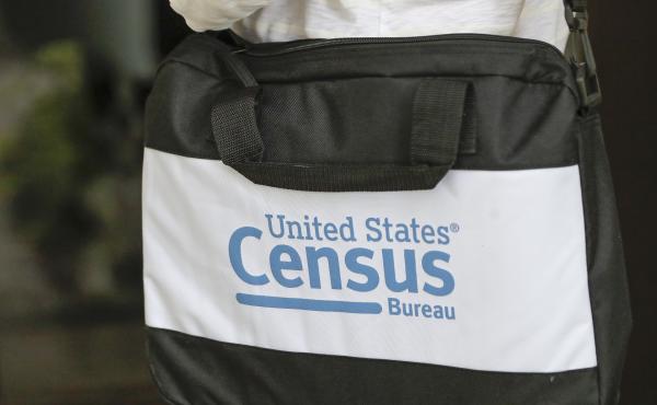 A U.S. Census Bureau worker carries a briefcase while knocking on the door of a home in August in Winter Park, Fla. A U.S. Census Bureau worker carries a briefcase while knocking on the door of a home in August in Winter Park, Fla.