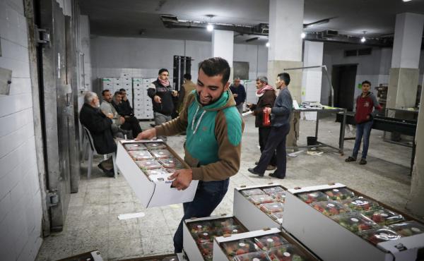 A worker piles boxes of strawberries inside the Ground Berries Association in northern Gaza. An unwritten deal between Israel and Hamas gives Gaza residents more access to jobs, trade and travel. A worker piles boxes of strawberries inside the Ground Berries Association in northern Gaza. An unwritten deal between Israel and Hamas gives Gaza residents more access to jobs, trade and travel.