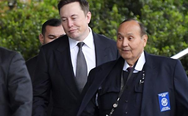 Tesla CEO Elon Musk (center) arrives at U.S. District Court in Los Angeles this week. Tesla CEO Elon Musk (center) arrives at U.S. District Court in Los Angeles this week.