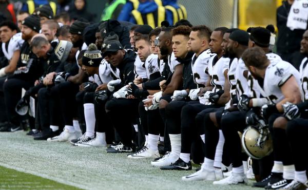 The New Orleans Saints kneel before the playing of the national anthem before the game against the Green Bay Packers at Lambeau Field on Oct. 22. The New Orleans Saints kneel before the playing of the national anthem before the game against the Green Bay Packers at Lambeau Field on Oct. 22.