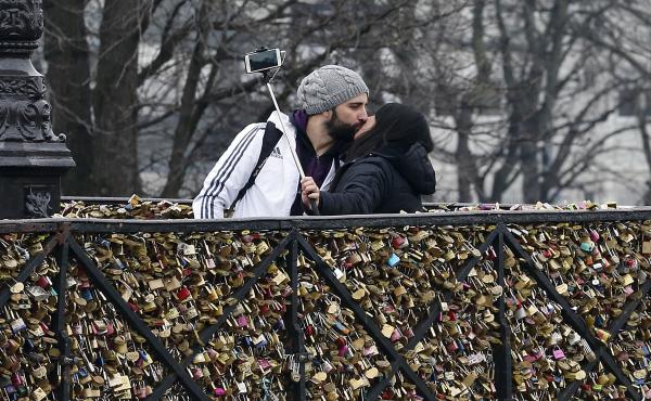 A couple kiss in front of love padlocks on the Pont Neuf in Paris. The city of Paris is organizing an auction of love locks from the Pont des Arts and other bridges, with profits going to groups that aid refugees. A couple kiss in front of love padlocks on the Pont Neuf in Paris. The city of Paris is organizing an auction of love locks from the Pont des Arts and other bridges, with profits going to groups that aid refugees.