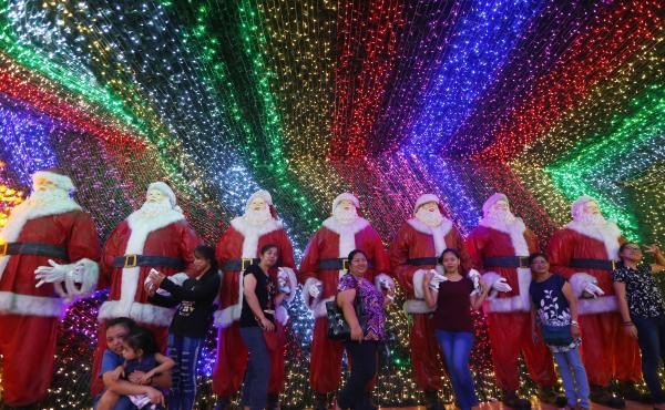 Filipinos pose for souvenir shots at the "Christmas House" owned by businessman Alexander Cruz in suburban Cainta, Rizal province, Philippines, on Dec. 12, 2017. The whole house, decorated with hundreds of thousands of LED lights, has attracted local and Filipinos pose for souvenir shots at the "Christmas House" owned by businessman Alexander Cruz in suburban Cainta, Rizal province, Philippines, on Dec. 12, 2017. The whole house, decorated with hundreds of thousands of LED lights, has attracted local and