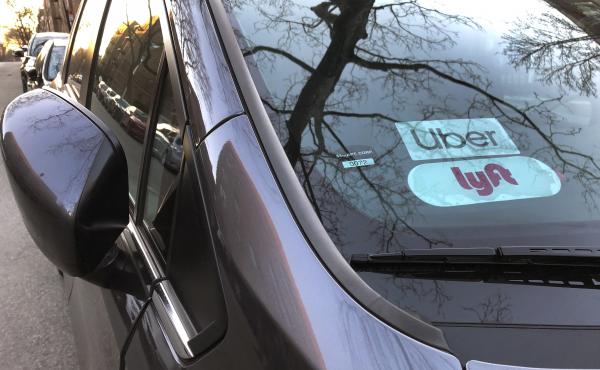 Uber and Lyft sign in windshield of car, Queens, New York. Uber and Lyft sign in windshield of car, Queens, New York.