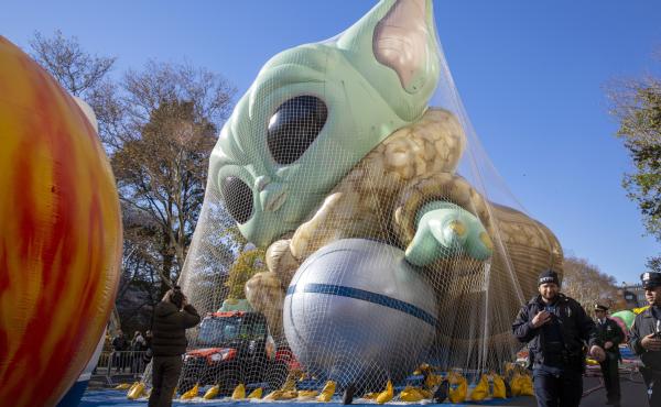 Police walk by an inflated helium balloon of Grogu, also known as Baby Yoda, from the Star Wars show The Mandalorian, on Wednesday in New York, as the balloon is readied for the Macy's Thanksgiving Day Parade on Thursday. Police walk by an inflated helium balloon of Grogu, also known as Baby Yoda, from the Star Wars show The Mandalorian, on Wednesday in New York, as the balloon is readied for the Macy's Thanksgiving Day Parade on Thursday.