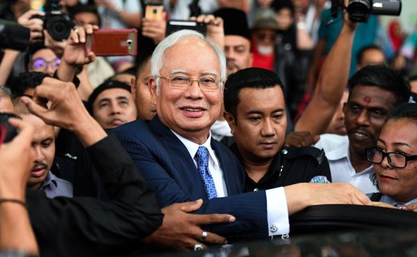 Najib Razak, Malaysia's former prime minister, leaves court in Kuala Lumpur on Wednesday — the first day in his trial over charges that he used a slush fund to put millions of dollars into his own accounts. Najib Razak, Malaysia's former prime minister, leaves court in Kuala Lumpur on Wednesday — the first day in his trial over charges that he used a slush fund to put millions of dollars into his own accounts.