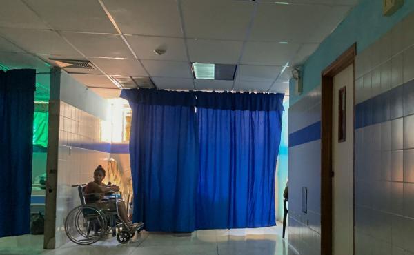 A patient on a wheelchair waits in the emergency room at a hospital in Güiria, Venezuela, on March 14. Human rights organizations recently warned that Venezuela faces catastrophic consequences from the new coronavirus pandemic, which threatens to overwhe A patient on a wheelchair waits in the emergency room at a hospital in Güiria, Venezuela, on March 14. Human rights organizations recently warned that Venezuela faces catastrophic consequences from the new coronavirus pandemic, which threatens to overwhe