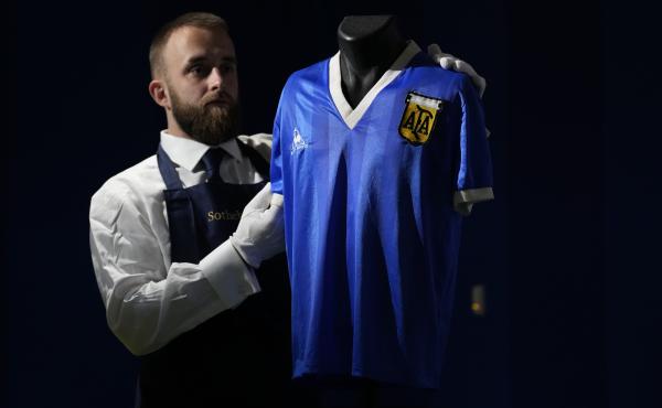 The Argentina football shirt worn by Diego Maradona in the 1986 Mexico World Cup quarterfinal soccer match between Argentina and England, is displayed for photographs at Sotheby's auction house, in London, on April 20. The shirt worn by Maradona when he s The Argentina football shirt worn by Diego Maradona in the 1986 Mexico World Cup quarterfinal soccer match between Argentina and England, is displayed for photographs at Sotheby's auction house, in London, on April 20. The shirt worn by Maradona when he s