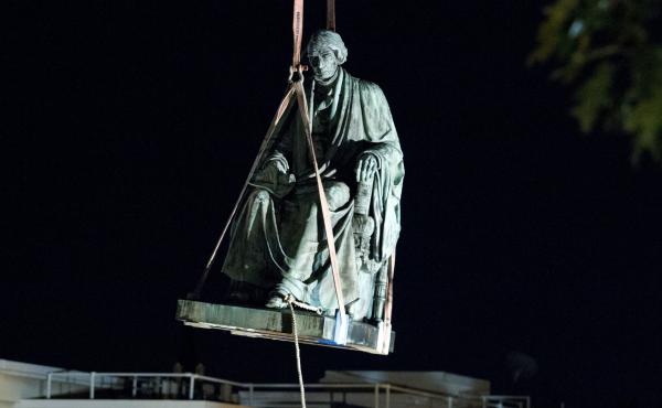 Workers use a crane to lift the monument dedicated to former Chief Justice of the United States Roger Taney in Annapolis, Md., early Friday. The State House Trust voted Wednesday to remove the statue from its grounds. Workers use a crane to lift the monument dedicated to former Chief Justice of the United States Roger Taney in Annapolis, Md., early Friday. The State House Trust voted Wednesday to remove the statue from its grounds.