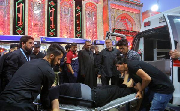 People evacuate an injured man after a walkway collapsed and set off a stampede as thousands of Shiite Muslims marked one of the most solemn holy days of the year in the holy city of Karbala, Iraq, on Tuesday. People evacuate an injured man after a walkway collapsed and set off a stampede as thousands of Shiite Muslims marked one of the most solemn holy days of the year in the holy city of Karbala, Iraq, on Tuesday.