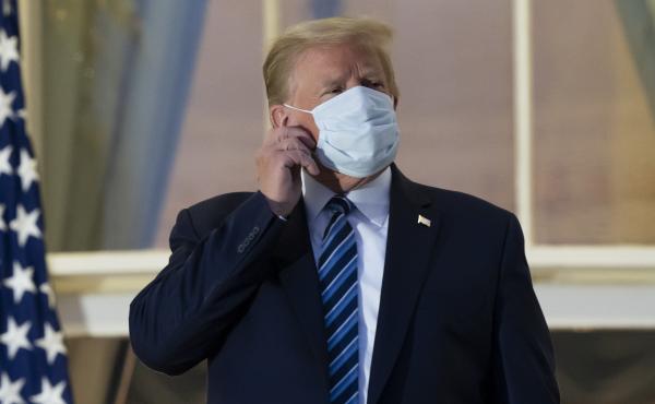 President Trump removes his mask upon returning to the White House on Monday after undergoing treatment for COVID-19 at Walter Reed National Military Medical Center in Bethesda, Md. President Trump removes his mask upon returning to the White House on Monday after undergoing treatment for COVID-19 at Walter Reed National Military Medical Center in Bethesda, Md.
