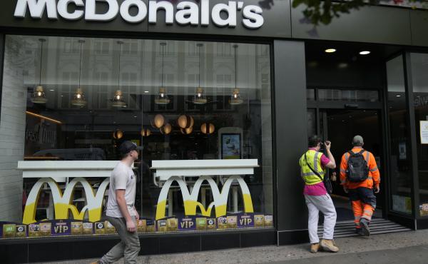 Customers walks into a McDonald's restaurant, in London on Aug. 24. McDonald's says it has pulled milkshakes from the menu in all 1,250 of its British restaurants because of supply problems stemming from a shortage of truck drivers. Customers walks into a McDonald's restaurant, in London on Aug. 24. McDonald's says it has pulled milkshakes from the menu in all 1,250 of its British restaurants because of supply problems stemming from a shortage of truck drivers.