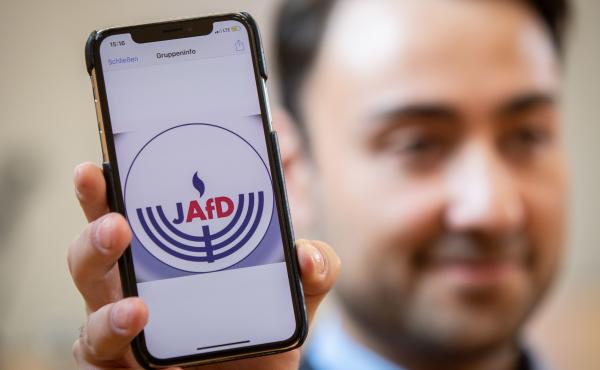 Leon Hakobian shows on his mobile phone a preliminary draft of a logo for a new Jewish grouping within Germany's far-right Alternative for Germany party, during the Jewish group's founding event on Oct. 7 in Wiesbaden, a city in Germany's western state of Leon Hakobian shows on his mobile phone a preliminary draft of a logo for a new Jewish grouping within Germany's far-right Alternative for Germany party, during the Jewish group's founding event on Oct. 7 in Wiesbaden, a city in Germany's western state of