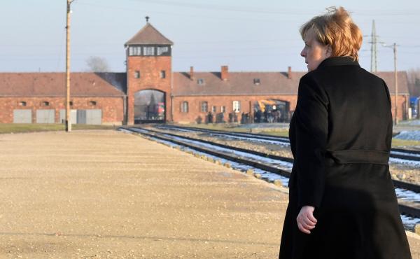 German Chancellor Angela Merkel walks toward the main railway entrance to Birkenau, the largest of the camps that made up the Auschwitz complex in Poland. It was the German chancellor's first visit to the former Nazi death camp, an enduring symbol of the German Chancellor Angela Merkel walks toward the main railway entrance to Birkenau, the largest of the camps that made up the Auschwitz complex in Poland. It was the German chancellor's first visit to the former Nazi death camp, an enduring symbol of the
